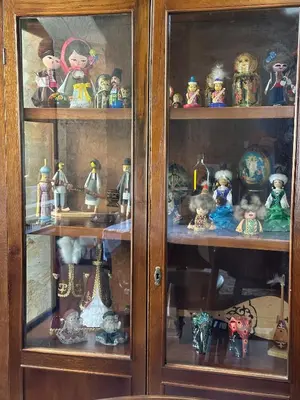 a wooden cabinet filled with lots of figurines at Cosy Piano village cottage in Pachna in Pachna
