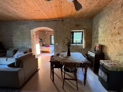 a living room with a table and a couch at Cosy Piano village cottage in Pachna in Pachna