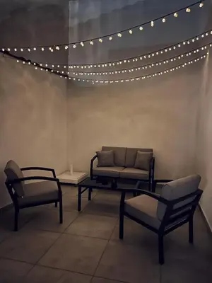 a living room with a couch and chairs and lights at Charming House in the Heart of Limassol in Limassol