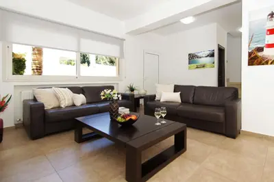 a living room with a couch and a table at Villa Michaella - 500m from Golden Beach in Paralimni