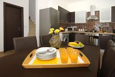 a kitchen with a table with glasses of orange juice at Villa Michaella - 500m from Golden Beach in Paralimni