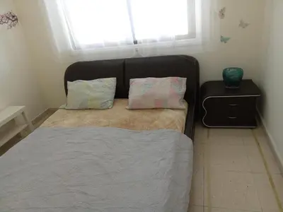 a small bedroom with a bed with a window at 2 bedroom apartment in Makenzi in Larnaka