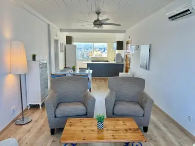 a living room with two chairs and a table at Seaview Beach Apartment Dasoudi in Limassol