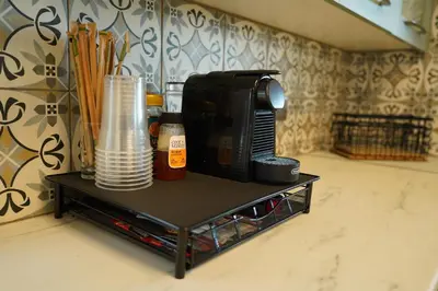 a coffee table with a microwave and cups on it at Oasis By The Sea - Cyprus in Larnaka