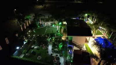 an overhead view of a courtyard at night with green lights at Oasis By The Sea - Cyprus in Larnaka
