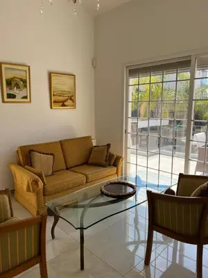 a living room with a couch and a glass table at Villa Sawa by Ezoria Villas in Limassol