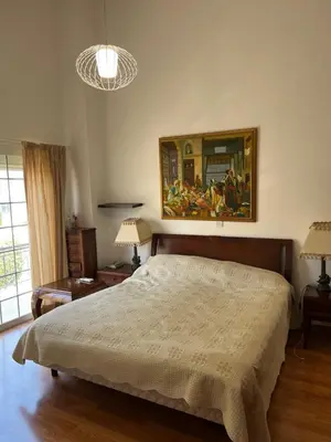 a bedroom with a bed and a painting on the wall at Villa Sawa by Ezoria Villas in Limassol