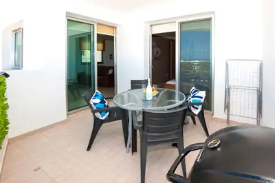 a glass table and chairs in a room at Sea View APT*Spacious balcony*200m to the Beach in Paralimni
