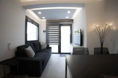 a living room with a couch and a table at Phaedrus Living: Luxury Mackenzie Flat in Larnaka