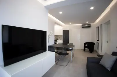 a living room with a large flat screen tv on a wall at Phaedrus Living: Luxury Mackenzie Flat in Larnaka
