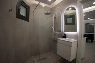 a bathroom with a shower with a toilet and a sink at Phaedrus Living: Luxury Mackenzie Flat in Larnaka