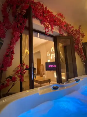a bathroom with a tub with flowers on the wall at Relaxing Gateway in Limassol in Episkopi Lemesou