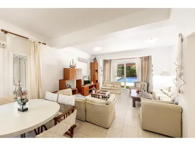 a living room with couches and a table at Protaras Apollon Seaside Villa in Protaras