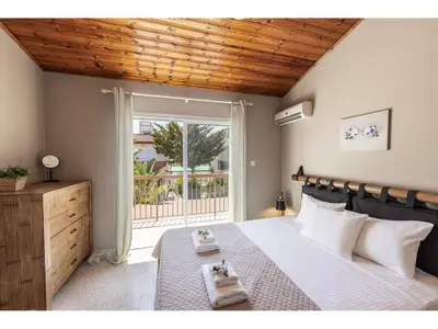 a bedroom with a large bed with towels on it at Anas Kiti Seaside Villa in Meneou