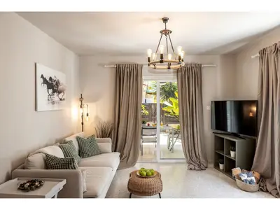 a living room with a couch and a tv at Anas Kiti Seaside Villa in Meneou