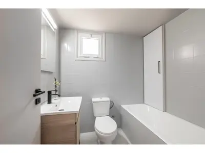 a white bathroom with a toilet and a tub and a sink at Anas Kiti Seaside Villa in Meneou