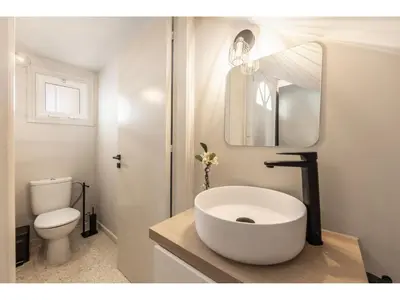 a white bathroom with a sink and a toilet at Anas Kiti Seaside Villa in Meneou