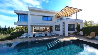 a house with a swimming pool in front of it at Billy's Place Protaras Luxury Villa with private pool with heated pool option for autumn and winter months in Paralimni