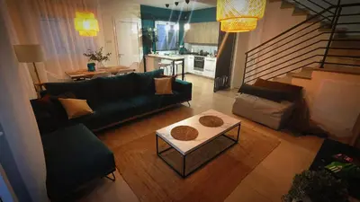 a living room with a couch and a table at My Mythical Pearl in Protaras