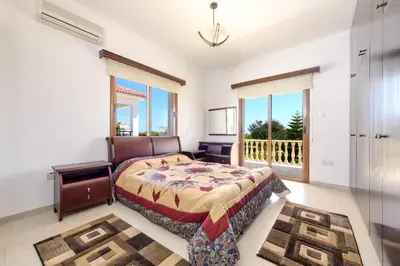 a bedroom with a bed and a balcony at Villa Sam in Ayia Napa