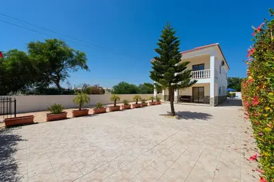 a house with a tree in the middle of a driveway at Villa Sam in Ayia Napa