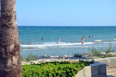people playing in the water at the beach at Meneou Blu Beach House* in Meneou