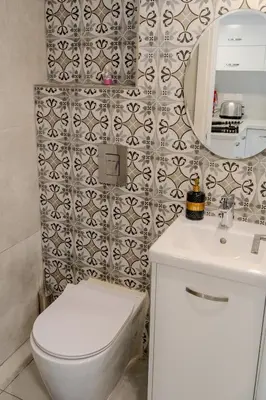 a bathroom with a white toilet and a mirror at Meneou Blu Beach House* in Meneou