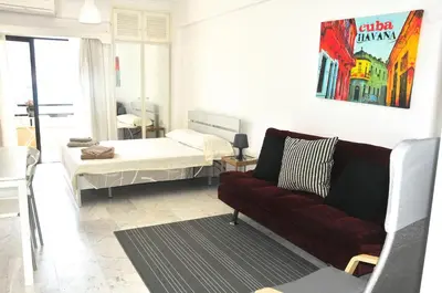 a living room with a couch and a bed at Stadem Studios in Larnaka