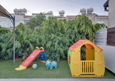 a childrens play area with a slide and a playground at Oroklini Star 200metres from the sandy beach in Larnaka