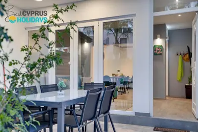 a table and chairs in front of a restaurant at Oroklini Star 200metres from the sandy beach in Larnaka