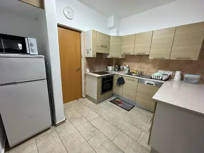 a kitchen with a white refrigerator and a stove at Sidra's Apartment in Paralimni