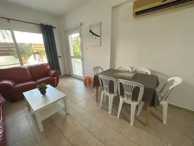 a living room with a table and chairs and a couch at Sidra's Apartment in Paralimni