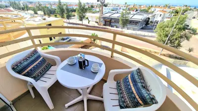 a balcony with a table and chairs on a balcony at Cyprus Dreams Village in Protaras