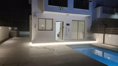 a room with a swimming pool with lights on it at Yama's Villa - Polyxenia luxury, protaras, cyprus in Protaras