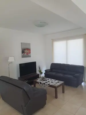 a living room with a couch and a coffee table at Yama's Villa - Polyxenia luxury, protaras, cyprus in Protaras