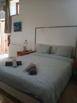 a bedroom with a bed with two towels on it at Skarinou Village Poolside Escape Studio with Pool facilities in Skarinou