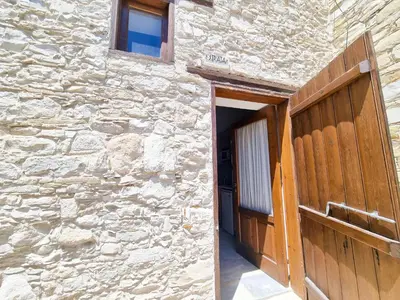 an entrance to a stone building with a wooden door at Skarinou Village Poolside Escape Studio with Pool facilities in Skarinou