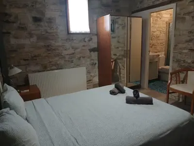 a bedroom with a bed with two teddy bears on it at Skarinou's Landhouse Poolside Heaven Apartment in Skarinou