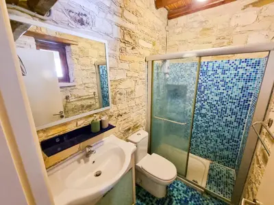 a bathroom with a sink and a toilet and a shower at Skarinou's Landhouse Poolside Heaven Apartment in Skarinou