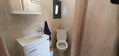 a small bathroom with a toilet and a sink at Village Gem Peledri Studio in Pelendri