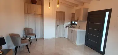 a small kitchen with a sink and a table and chairs at Village Gem Peledri Studio in Pelendri