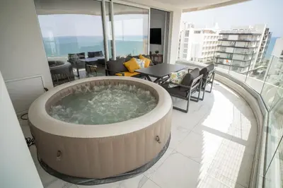 a hot tub in the middle of a room at Seaview Pearl in Mackenzie with Pool & Jacuzzi in Larnaka