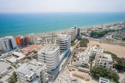 an aerial view of a city with buildings and the ocean at Seaview Pearl in Mackenzie with Pool & Jacuzzi in Larnaka