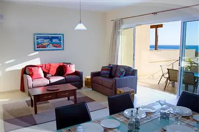 a living room with a couch and a table at Anastasia in Pissouri