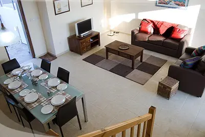 a living room with a table and a couch at Anastasia in Pissouri