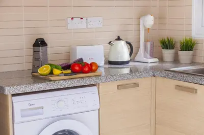 a kitchen counter with a dishwasher and a plate of vegetables at Villa Cliantha in Protaras