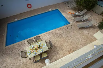 an overhead view of a table and chairs next to a swimming pool at Villa Cliantha in Protaras