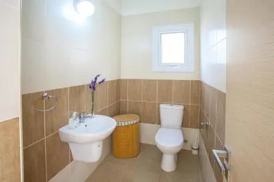 a bathroom with a toilet and a sink at Villa Cliantha in Protaras