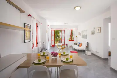 a dining room and living room with a table and chairs at Liora Suite in Protaras