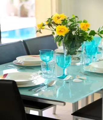 a table with a vase of yellow flowers on it at Michelle 8 in Protaras
